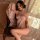 Woman modeling mannyan sensual lace lingerie set featuring a sheer mesh bra top and floral kimono-style robe with shimmer det...