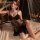Elegant black lace sleepwear featuring sheer design, deep v-neck, high slit, and mesh details, perfect for sensuous nights.