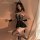 Woman wearing mannyan sexy lace bodysuit set with cat ears, sheer stockings, and maid-style trim in sultry pose.