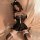 Woman wearing mannyan sexy lace bodysuit set with cat ears, sheer black lace top, ruffled skirt, and matching stockings.