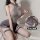Woman modeling mannyan sexy lingerie set – gray mesh bodysuit with jk-style pleated skirt, thigh-highs, and open-back detail.