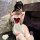 Woman wearing mannyan sexy maid costume set with sheer low-cut top, red bow, detachable skirt, fishnet stockings, and fluffy ...