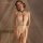 Woman modeling mannyan sheer halter bodysuit with lace detailing and open-crotch design for intimate moments.