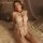 Woman wearing mannyan sheer halter bodysuit with lace detailing and open-crotch design, styled for intimate moments on a roma...