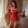 A woman poses elegantly wearing a red mannyan sexy new year lingerie set, featuring a sparkling mesh halter dress with adjust...