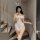Woman modeling white bunny bodysuit with ruffles, sheer panels, and open-crotch design — mannye qing plus size lace costume w...