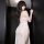 Woman wearing mannye qing sensual lingerie dress, sheer mesh slip with deep slit and plunge bustier, back view.