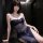 Woman wearing mannye qing sheer mesh lingerie dress with deep slit and plunge bustier in dark hallway.