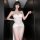 Woman wearing mannye qing sheer mesh lingerie dress with deep slit and plunge bustier, featuring heart embellishments.