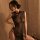 Woman wearing black sheer mesh cheongsam lingerie with high slit and no-remove design for seductive role play.