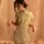 A woman models a sheer green cheongsam dress featuring floral embroidery, high neck, and tie-front design, perfect for vintag...