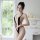 Woman wearing black mannyqing sexy backless lace bodysuit with deep v, cut-outs, and open crotch design in bright room.