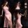 Pink sheer mesh dress with high slit and bow detail, backless design, perfect for evening wear.