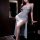 Elegant sheer mesh dress featuring high-slit design, backless style with delicate bow details, perfect for evening elegance.