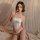 Woman wearing white lace camisole and crotchless panties from mannyqing pure & seductive sleepwear set on bed.