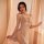 Elegant sheer lace cami nightgown with adjustable tie-back design, perfect for sensual lounging.
