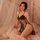 Elegant black lace sheer cami nightgown with adjustable tie-back design, perfect for sensual lounging.
