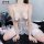 Sheer white lingerie nightdress with lace trim and tassels, designed for small busts, worn by a model on a black rug with dec...