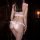 Woman wearing pink and white sailor-style lingerie set with ruffles, back view showing seductive design.