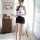A woman models the mannyqing secretarial costume set, featuring a strapless tie blouse paired with a backless striped mini sk...