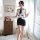 A woman models the mannyqing secretarial costume set, featuring a strapless tie blouse with a backless striped mini skirt, pe...