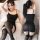 Woman modeling black mannyqing sensual lace bodysuit dress with sheer backless design and thigh-high stockings.