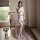 Woman modeling mannyqing sensual lace bodysuit with sheer mesh tights, featuring backless design and satin finish in elegant ...