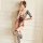 Woman modeling mannyqing sensual lace bodysuit with sheer mesh tights, featuring backless design and red devil horns.
