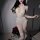 Woman wearing mannyqing sexy deep v lace bodysuit with sheer mesh, cross-back design, and open-crotch detail, posing with red...