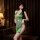 Elegant green cheongsam with deep v neckline and slit design, featuring pearl embellishments and lace camisole set for pure a...