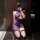 Woman kneeling in purple mannyqing sexy lingerie set with sheer split skirt, halter tie, and ruched bodycon dress.
