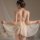 Woman wearing mannyqing sheer mesh lace cami nightdress with backless cutout design, flowing fabric, and delicate straps.