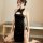 Vintage-inspired black cheongsam with lace cutouts and ties, exuding seductive elegance.