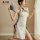 Vintage-inspired cheongsam with lace cutouts and ties, elegant design, perfect for evening wear.