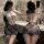 Woman modeling manyan ol secret cosplay uniform: sheer plaid bodysuit with backless design and bodycon skirt, posing in bathr...