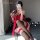 A woman poses with a smartphone, wearing a red chinese-style halter bodice set featuring floral embroidery and lace details, ...