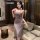 A woman wearing a form-fitting, sleeveless sleep dress with a plunging neckline and lace detailing, highlighting its sexy and...