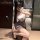 Woman wearing manyan pure & tempting halter neck bodycon skirt set with sheer backless top, posing in mirror selfie.