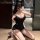 Woman kneeling in black manyan off-shoulder bodycon mini dress with cat ears, taking mirror selfie — sexy nightclub slip dres...