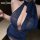 Woman wearing blue shimmer halter dress with deep neckline and backless design, perfect for nightclub or lingerie look.