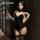 Woman modeling manyan sexy bunny costume set: black velvet lingerie with open-crotch design, garter straps, and lace thigh-hi...