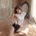 A woman poses in a serene room, wearing a manyeqing schoolgirl-style lingerie set featuring sheer cutouts and lace details. t...