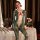Woman wearing mei xing qing snake-print bodysuit lingerie, sheer chest panel, elegant table setting with candles and roses.