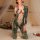 Woman wearing green snake print mei xing qing lingerie set kneeling on bed with floral decor.