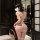 Woman wearing pink meimei lingerie set with sheer lace and stockings, back view in elegant room setting.
