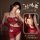 A woman wearing a red halter bodysuit with floral embroidery, designed for vintage belly dance inspiration. the outfit featur...