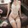 Woman wearing white meiyoujia lace halter bodysuit with sheer panels and matching thigh-high stockings, seated on leather sof...