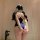 A woman stands facing away from the camera, wearing a midnight blue bodysuit with white lace detailing on the straps. the des...