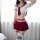 Woman wearing red and white sailor-style lingerie set with pleated skirt, crop top, garter straps, and striped thigh-high soc...