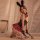 A woman poses in a bunny girl pvc plaid outfit, featuring a black bodice, red skirt, bunny ears, fishnet stockings, and glove...